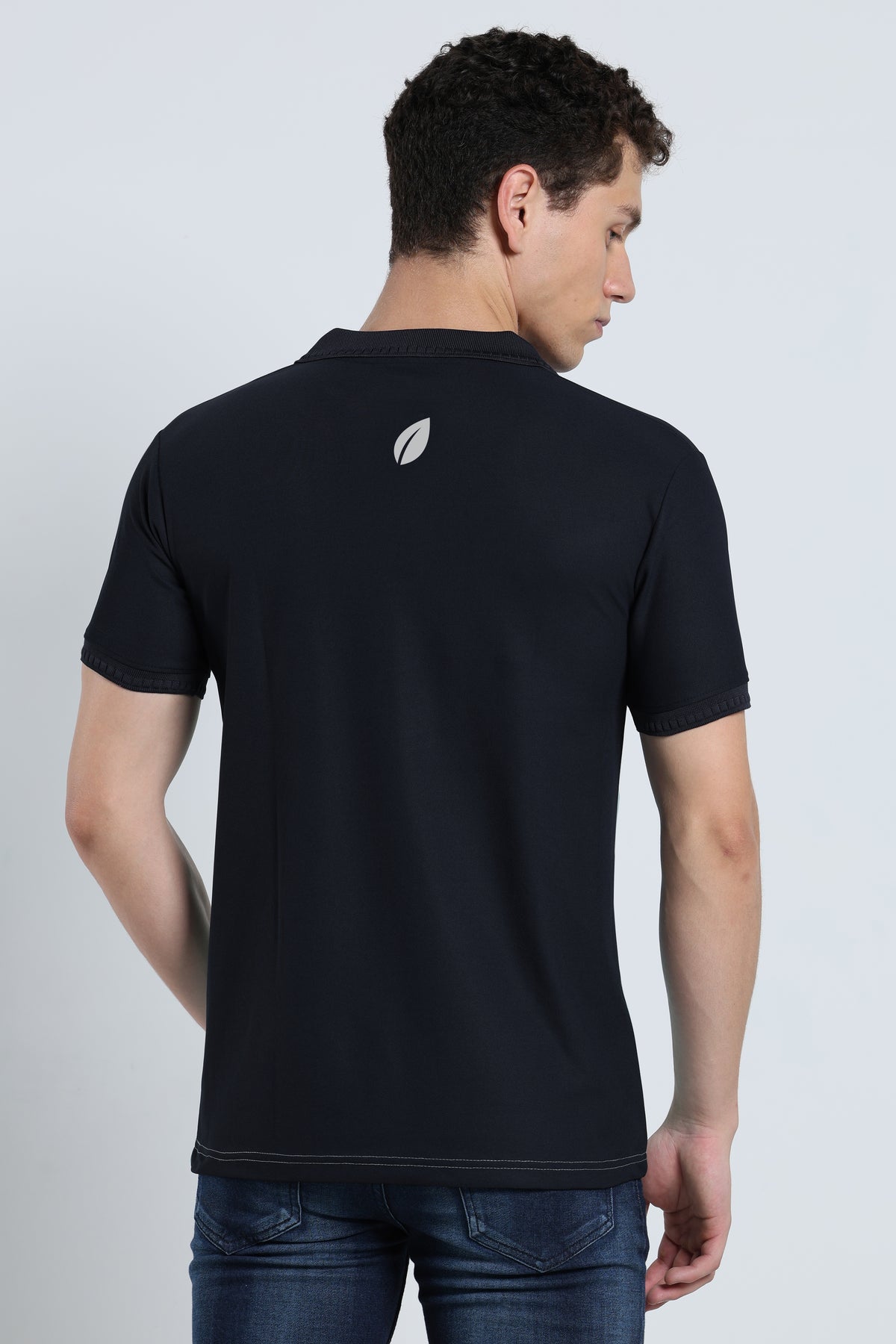 Back view of men's black activewear polo t-shirt with subtle logo