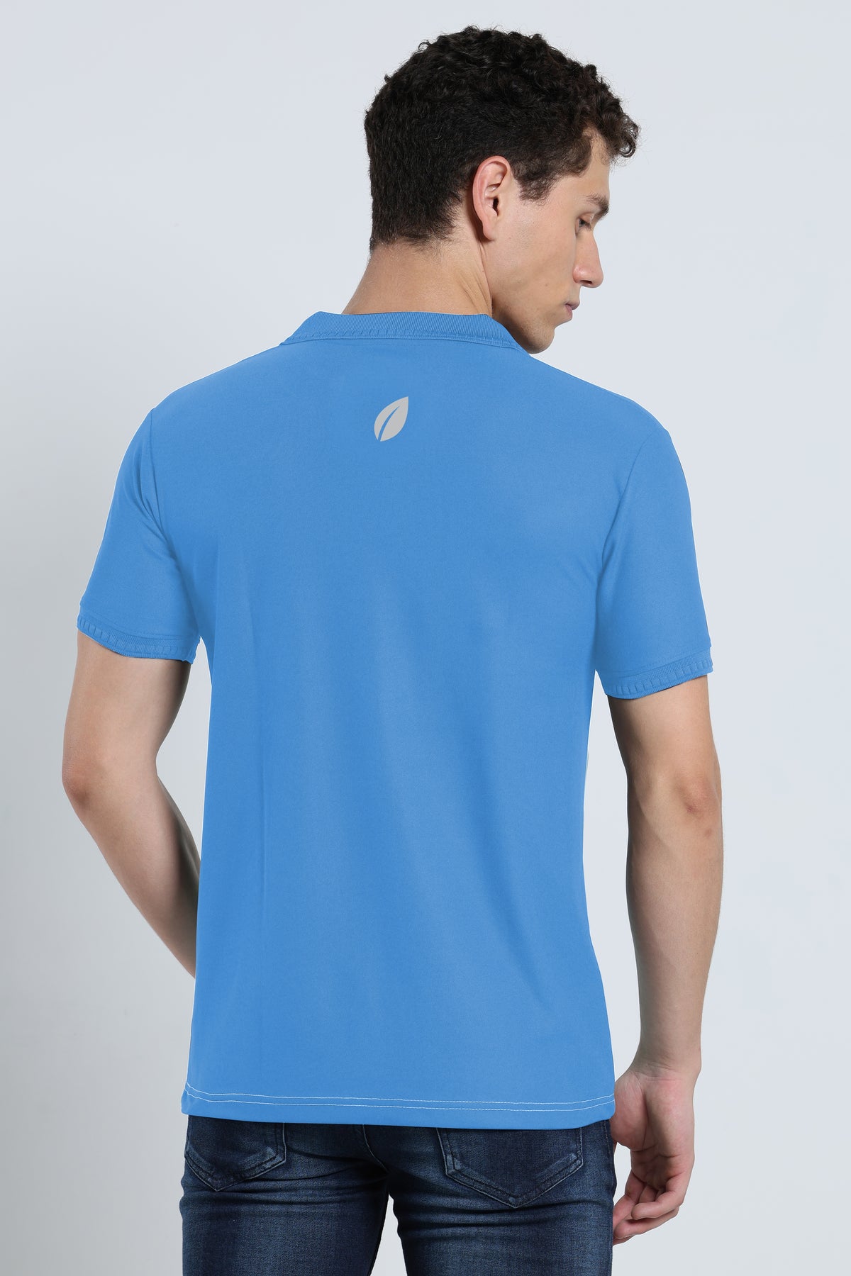 Back view of men's sky blue activewear polo t-shirt with subtle logo